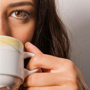 woman drinking with coffee cup
