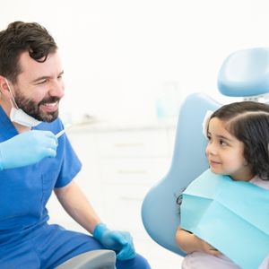 Dentist with Smiling Child Patient