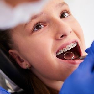 young girl with braces getting a checkup