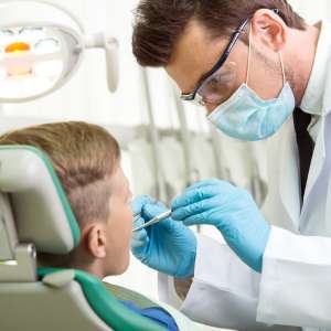 Calm dentist working on child