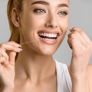 Woman flossing her teeth