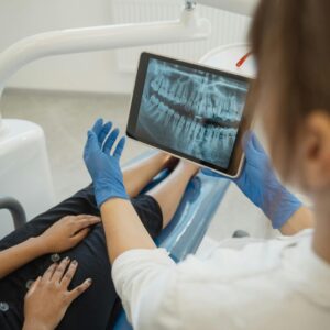 Looking at dental x-ray with patient